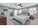 Comfortable bedroom featuring a ceiling fan, ensuite bathroom, and natural light from the windows at 8637 E Jackrabbit Rd, Scottsdale, AZ 85250