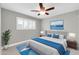 Stylized bedroom with light gray walls, ceiling fan, blue accents, and a large window with shutters at 8637 E Jackrabbit Rd, Scottsdale, AZ 85250