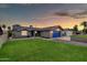 Charming single-story home featuring a well-maintained lawn and a brightly colored garage door at 8637 E Jackrabbit Rd, Scottsdale, AZ 85250