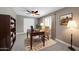 Home office featuring a wooden desk and chair, built-in shelving, ceiling fan, and natural light at 8637 E Jackrabbit Rd, Scottsdale, AZ 85250