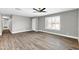 Bright living room featuring hardwood floors and large windows with shutter-style blinds at 8637 E Jackrabbit Rd, Scottsdale, AZ 85250