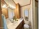 Bathroom with white sink, wood cabinets, and a large mirror at 864 S Motherlode Dr, Apache Junction, AZ 85119