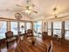 Cozy dining area with a ceiling fan, large windows, and adjacent seating area leading to outdoor patio at 864 S Motherlode Dr, Apache Junction, AZ 85119