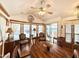 Charming dining area with a ceiling fan, large windows, and adjacent seating area with natural light at 864 S Motherlode Dr, Apache Junction, AZ 85119