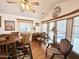 Inviting dining area features a ceiling fan and natural light from the surrounding large windows at 864 S Motherlode Dr, Apache Junction, AZ 85119