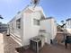 White exterior home features gravel landscaping, a window, and an air conditioning unit at 864 S Motherlode Dr, Apache Junction, AZ 85119