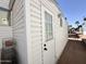 The white exterior of this home features a door with a multi-pane window at 864 S Motherlode Dr, Apache Junction, AZ 85119