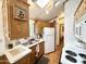 A bright kitchen with a skylight, white appliances, and wood cabinetry at 864 S Motherlode Dr, Apache Junction, AZ 85119