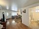 Comfortable living room with wood-look floors leads to a bathroom with a corner shower at 864 S Motherlode Dr, Apache Junction, AZ 85119