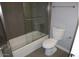 Modern bathroom features a tub, glass shower door and toilet at 925 W Mcdowell Rd # 102, Phoenix, AZ 85007