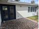 Cozy brick patio outside with double doors and green grass at 925 W Mcdowell Rd # 102, Phoenix, AZ 85007