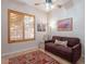 Cozy bedroom with plantation shutters, ceiling fan, and comfortable sofa at 9431 N Summer Hill Blvd, Fountain Hills, AZ 85268