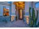 Close-up view of the home's entrance with a decorative front door and desert-themed landscaping at 9431 N Summer Hill Blvd, Fountain Hills, AZ 85268