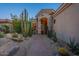 Inviting front entrance of a home with desert landscaping and decorative stone pillars at 9431 N Summer Hill Blvd, Fountain Hills, AZ 85268