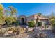 Desert-style home with well-maintained landscaping, including cacti and native plants in a rock garden at 9431 N Summer Hill Blvd, Fountain Hills, AZ 85268