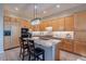 A kitchen showcasing granite counters, wood cabinets, and a kitchen island with barstool seating at 9431 N Summer Hill Blvd, Fountain Hills, AZ 85268