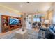 Bright living room with seamless flow into the dining area, featuring a large TV at 9431 N Summer Hill Blvd, Fountain Hills, AZ 85268