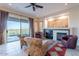 Inviting living room with a cozy fireplace and sliding glass doors to the patio at 9431 N Summer Hill Blvd, Fountain Hills, AZ 85268