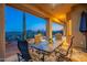 Covered patio with outdoor dining furniture overlooking the swimming pool and desert landscaping at 9431 N Summer Hill Blvd, Fountain Hills, AZ 85268