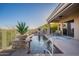 Inviting pool area with a waterfall feature, lush greenery, and a covered patio for relaxing and entertaining at 9431 N Summer Hill Blvd, Fountain Hills, AZ 85268