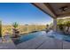 Beautiful backyard pool with desert views, potted plants, and a covered patio area at 9431 N Summer Hill Blvd, Fountain Hills, AZ 85268