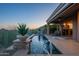 Inviting pool featuring desert landscaping and sliding glass doors to the interior living space at 9431 N Summer Hill Blvd, Fountain Hills, AZ 85268