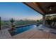 Desert landscaping accents the backyard swimming pool and patio with ceiling fan at 9431 N Summer Hill Blvd, Fountain Hills, AZ 85268