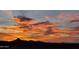 Panoramic sunset view overlooking the desert landscape; fiery clouds paint the sky with vibrant colors, creating a serene vista at 9431 N Summer Hill Blvd, Fountain Hills, AZ 85268