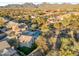 Scenic aerial view of the property in its neighborhood with mountain views in the background at 9727 E Presidio Rd, Scottsdale, AZ 85260