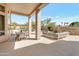 Inviting covered patio with comfortable seating, offering a serene outdoor living space overlooking a lush backyard at 9727 E Presidio Rd, Scottsdale, AZ 85260