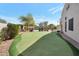 Expansive backyard with a putting green, mature landscaping, and outdoor seating area at 9727 E Presidio Rd, Scottsdale, AZ 85260