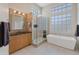 Modern bathroom featuring a glass enclosed shower and soaking tub at 9727 E Presidio Rd, Scottsdale, AZ 85260