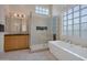 Bathroom with glass walk-in shower, soaker tub, and neutral paint at 9727 E Presidio Rd, Scottsdale, AZ 85260