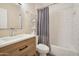 Well-lit bathroom with a modern vanity and a tiled shower-tub combo at 9727 E Presidio Rd, Scottsdale, AZ 85260