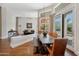 Bright dining area features a rustic table and chairs, complemented by backyard views and stylish lighting at 9727 E Presidio Rd, Scottsdale, AZ 85260