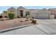 Beautiful home exterior with a well-manicured front yard and a two-car garage at 9727 E Presidio Rd, Scottsdale, AZ 85260