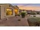 Charming home exterior with arched windows and desert landscaping at sunset at 9727 E Presidio Rd, Scottsdale, AZ 85260