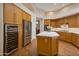 Modern kitchen with stainless steel appliances, island with breakfast bar, and a wine cooler at 9727 E Presidio Rd, Scottsdale, AZ 85260