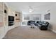 Cozy living room with built-in shelves, plush sectional, and neutral carpet at 9727 E Presidio Rd, Scottsdale, AZ 85260