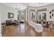 Bright and airy living room featuring hardwood floors, large windows, and a dining area at 9727 E Presidio Rd, Scottsdale, AZ 85260