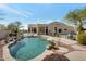 Backyard pool with a rock waterfall feature surrounded by desert landscaping at 9727 E Presidio Rd, Scottsdale, AZ 85260