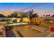 Backyard pool with a built in grill and patio furniture under twilight skies at 9727 E Presidio Rd, Scottsdale, AZ 85260