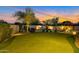 Lush backyard putting green surrounded by desert landscaping perfect for outdoor entertainment at 9727 E Presidio Rd, Scottsdale, AZ 85260