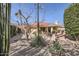 Landscaped backyard with patio seating, a built-in grill, and mature trees at 9803 N 100Th Pl, Scottsdale, AZ 85258