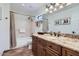 Bathroom features a large mirror, granite countertops, and a shower-tub combo at 9803 N 100Th Pl, Scottsdale, AZ 85258