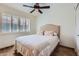 Comfortable bedroom with a ceiling fan and a large window for natural light at 9803 N 100Th Pl, Scottsdale, AZ 85258