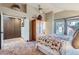 Cozy bedroom with an en-suite, high ceilings, and a large sliding glass door for natural light at 9803 N 100Th Pl, Scottsdale, AZ 85258