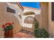 Charming courtyard entry with a decorative wall feature and potted plants at 9803 N 100Th Pl, Scottsdale, AZ 85258