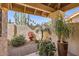 Secluded courtyard featuring desert plants, statue, and textured privacy wall at 9803 N 100Th Pl, Scottsdale, AZ 85258