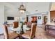 Dining room with modern chandelier and views into the living room at 9803 N 100Th Pl, Scottsdale, AZ 85258